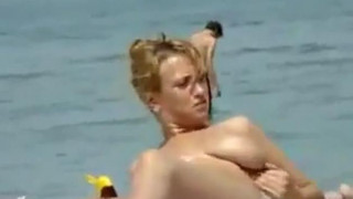 Oiling boobs on topless beach