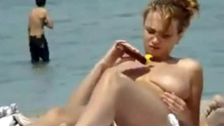 Oiling boobs on topless beach