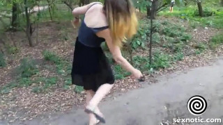 Girl walks in the Park with naked booty